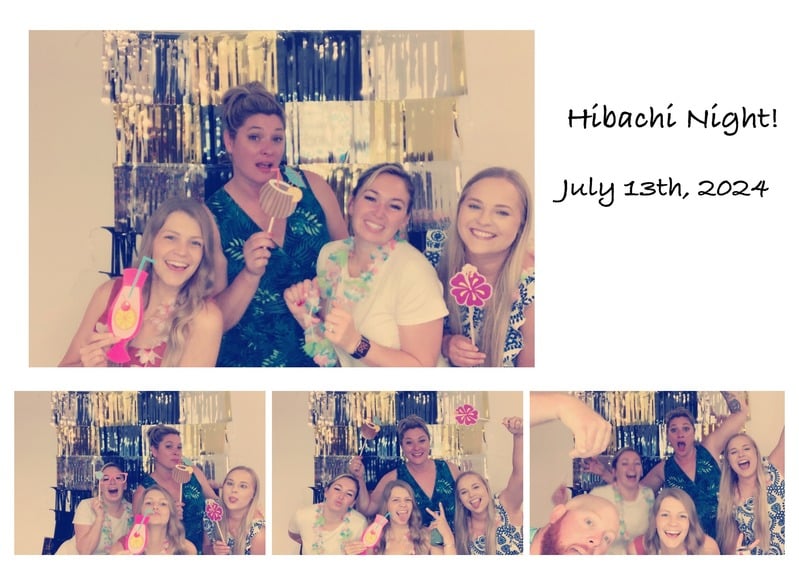 Four women posing with fun props at a party photo booth